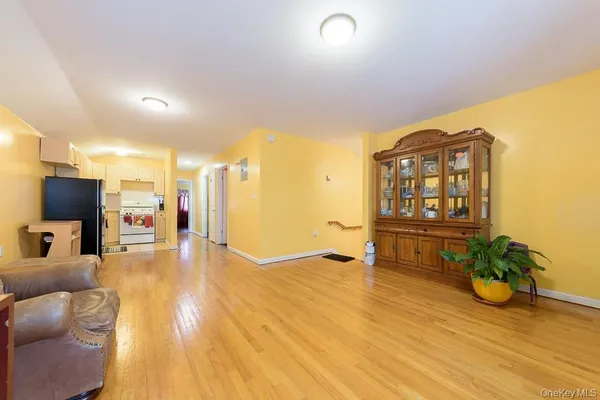 a view of a living room a dining room with wooden floor and furniture