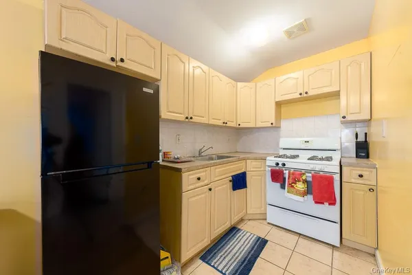 a kitchen with stainless steel appliances granite countertop a refrigerator sink and stove