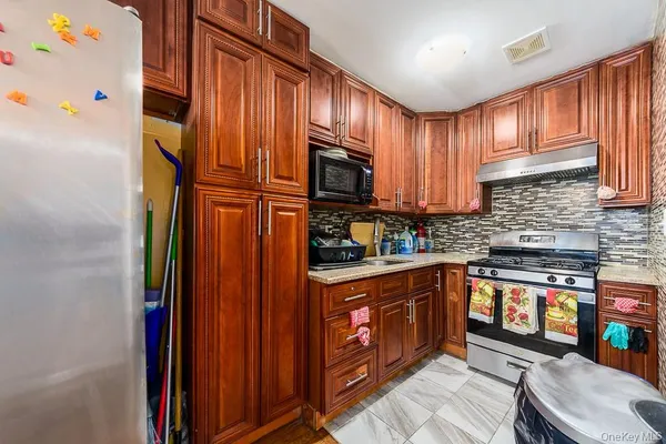 a kitchen with stainless steel appliances granite countertop a stove top oven a sink and dishwasher