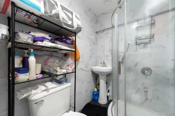 a bathroom with a sink a toilet and shower