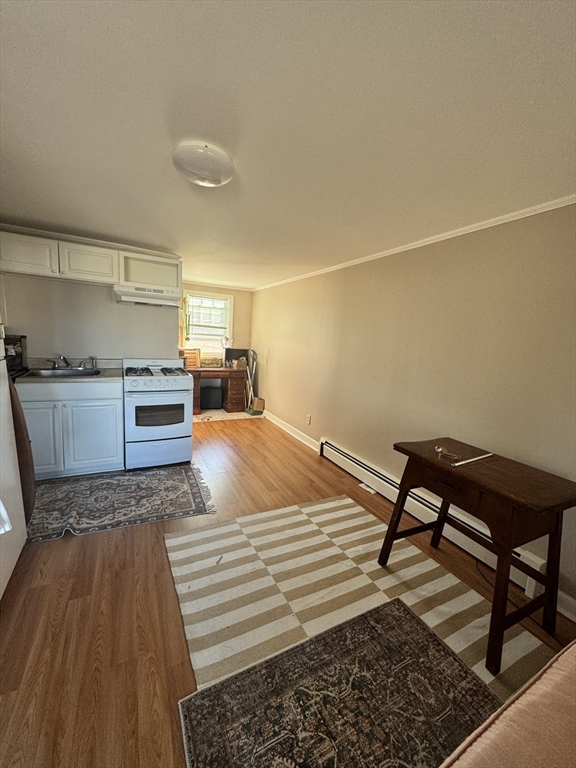 2667 Cranberry Highway, Unit 7 Wareham, MA 02571 - Photo 1 of 17 a bedroom with a bed and wooden cabinets