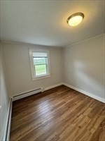 2667 Cranberry Highway, Unit 7 Wareham, MA 02571 - Photo 11 of 17 an empty room with wooden floor and windows