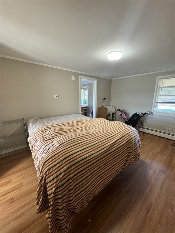 2667 Cranberry Highway, Unit 7 Wareham, MA 02571 - Photo 12 of 17 a bedroom with a bed and wooden floor