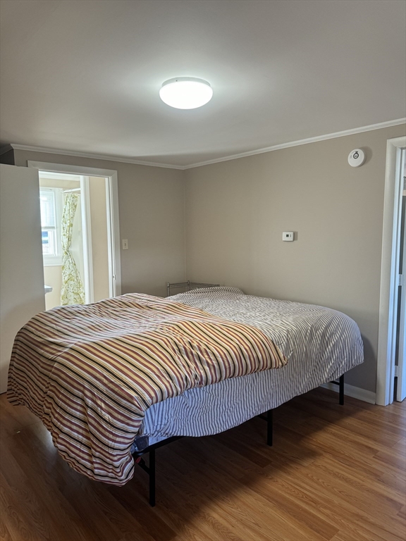 2667 Cranberry Highway, Unit 7 Wareham, MA 02571 - Photo 17 of 17 a bedroom with a bed and wooden floor