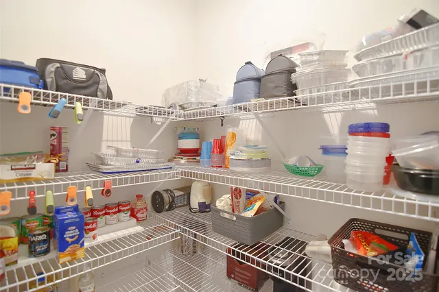 a kitchen with lots of clutter and stainless steel appliances