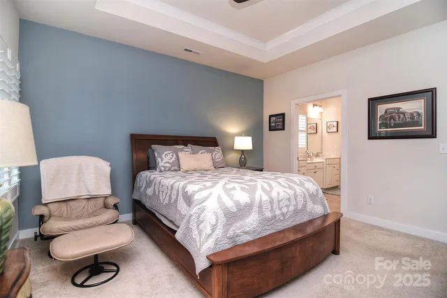 a bedroom with a bed and a chair