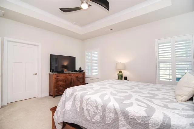 a bedroom with a bed and a television