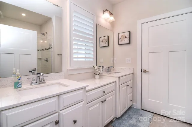 a bathroom with double sink and a mirror