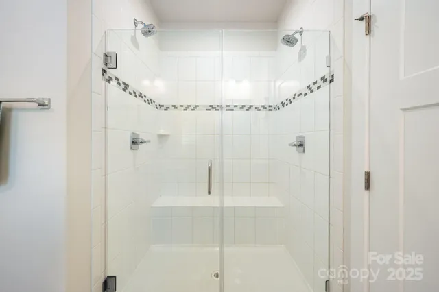 a bathroom with a glass shower door