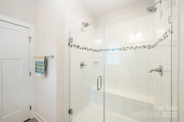 a bathroom with a glass shower door