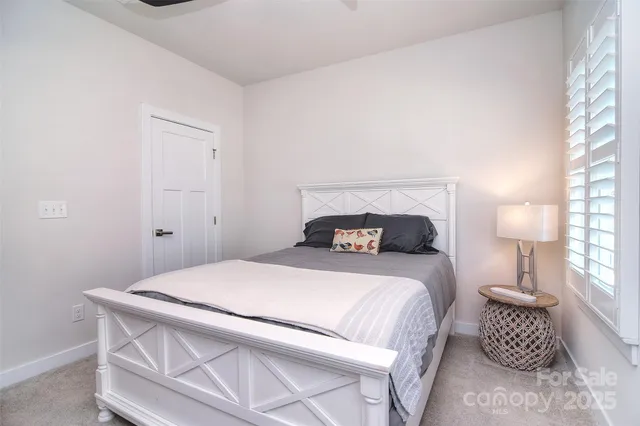 a bedroom with a bed and a lamp