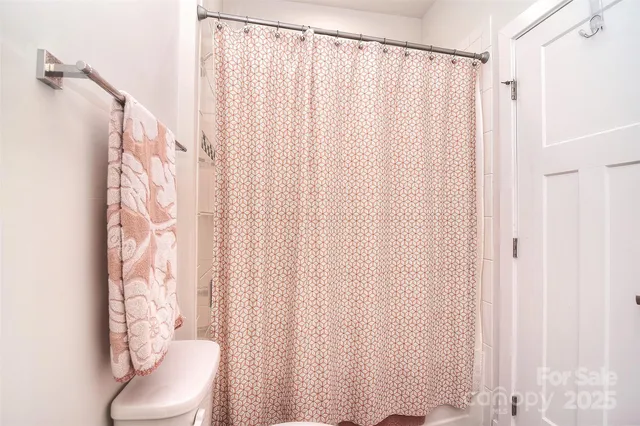 a bathroom with a shower curtain and a curtain