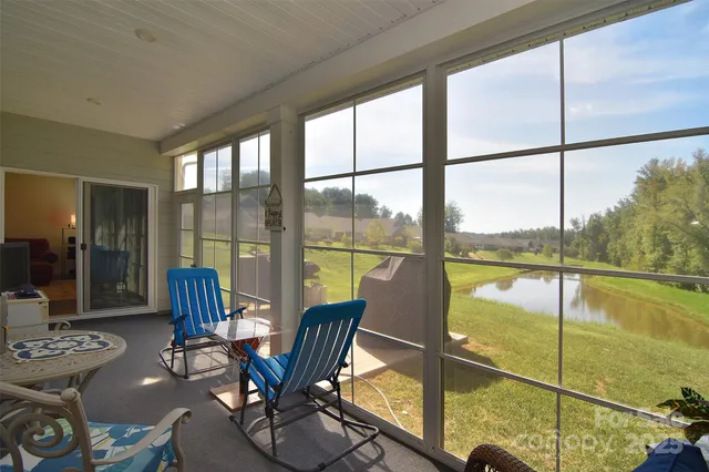 a dining room with furniture and floor to ceiling window