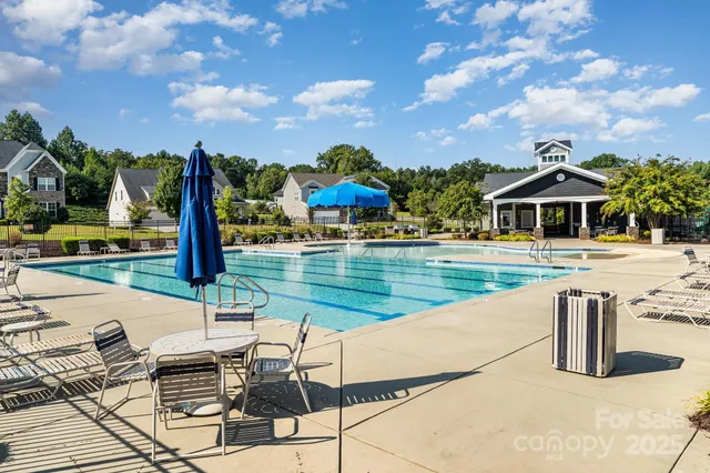 a swimming pool with outdoor seating and city view