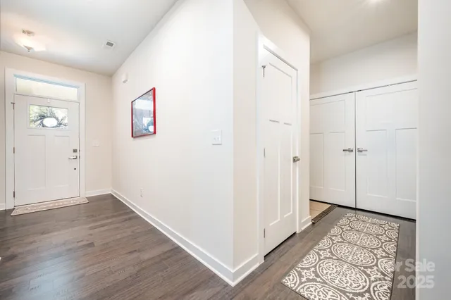 an empty room with wooden floor and a window