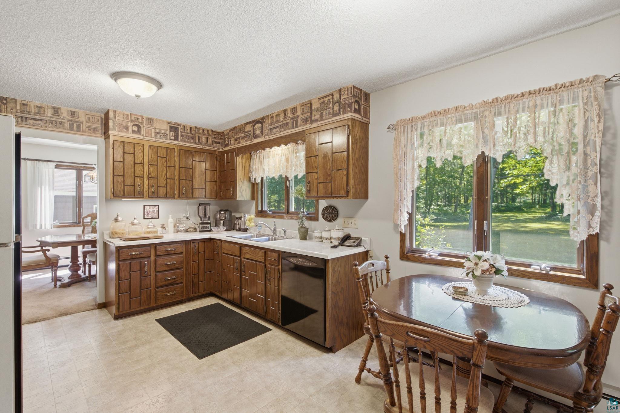27485 South Kane Road Ashland, WI 54806 - Photo 7 of 35 Kitchen featuring wood cabinetry, white countertops, built-in dishwasher, and recessed ceiling lighting