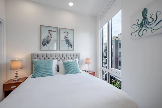 a bedroom with bed and night stand