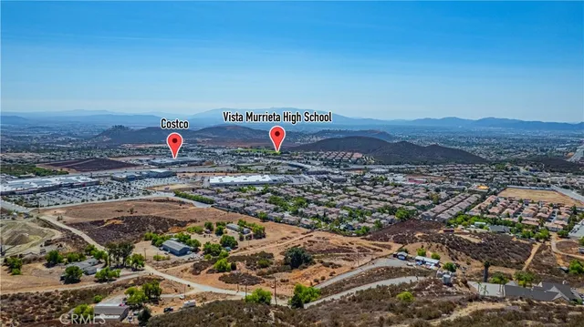 an aerial view of a houses with a yard