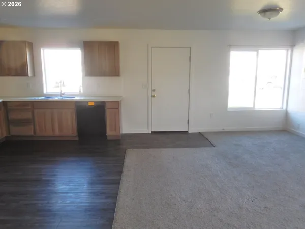 a kitchen with granite countertop a sink and a stove top oven