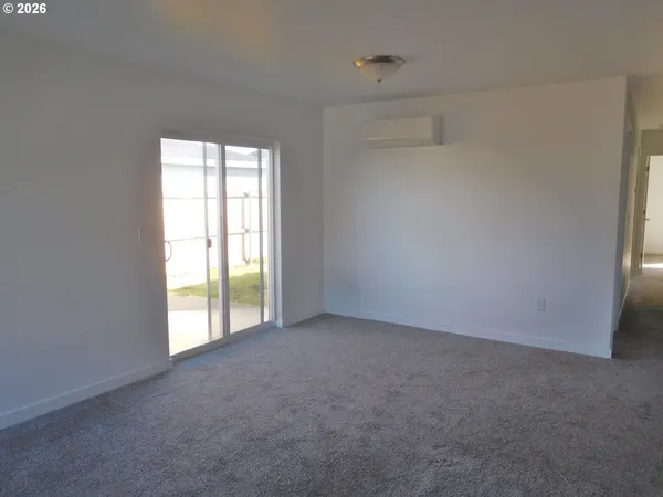 an empty room with wooden floor and closet