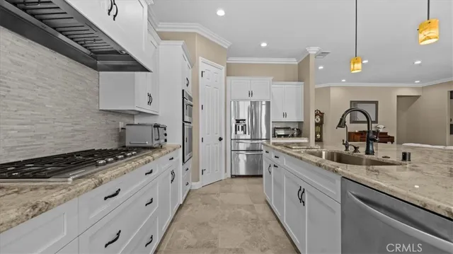 a kitchen with stainless steel appliances a sink stove and cabinets