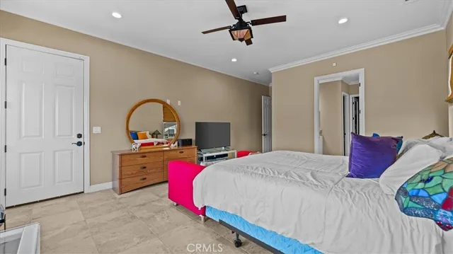 a bedroom with a bed and a potted plant