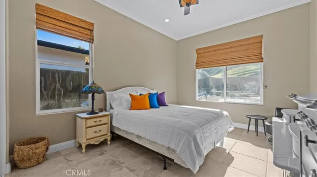 a bedroom with a bed a table and with a window