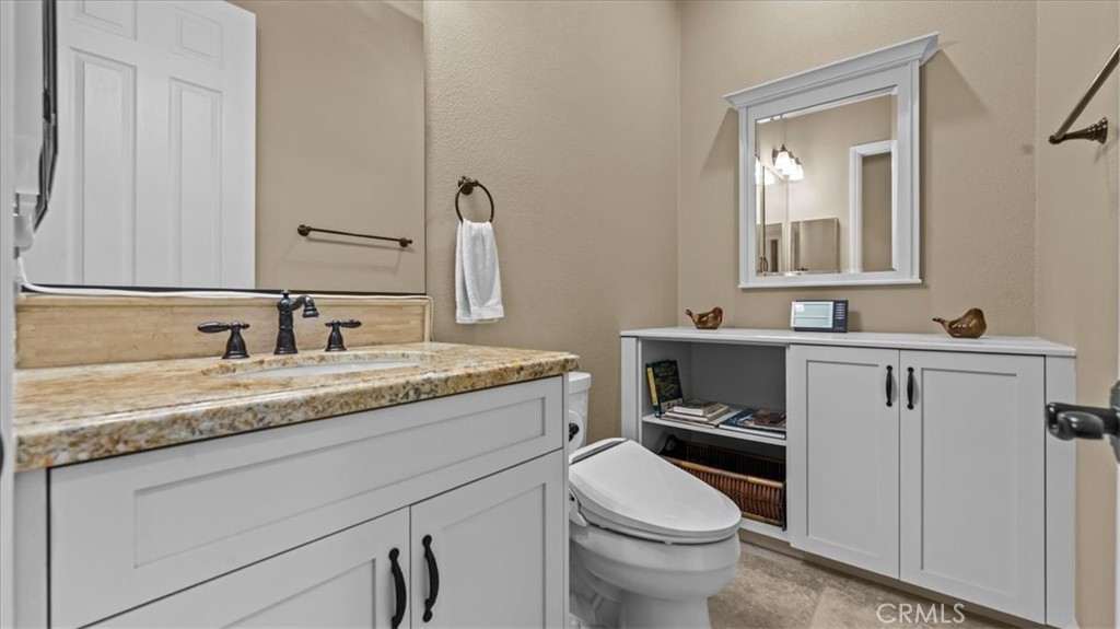 3059 Mill Creek Road Mentone, CA 92359 - Photo 21 of 39 a bathroom with a granite countertop toilet sink and mirror