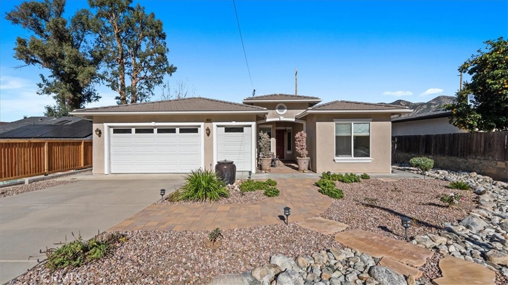 3059 Mill Creek Road Mentone, CA 92359 - Photo 3 of 39 a front view of a house with a yard