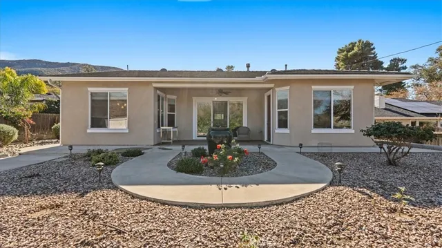 an aerial view of multiple houses with a yard