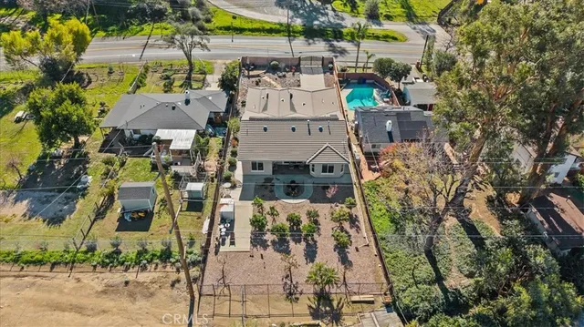 an aerial view of a house with a yard and large trees
