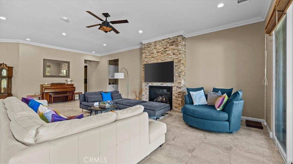 3059 Mill Creek Road Mentone, CA 92359 - Photo 6 of 39 a living room with furniture a fireplace and a flat screen tv