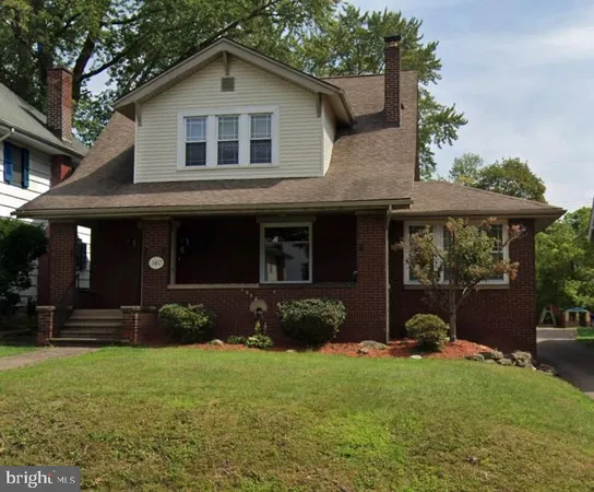 a front view of a house with a yard and porch