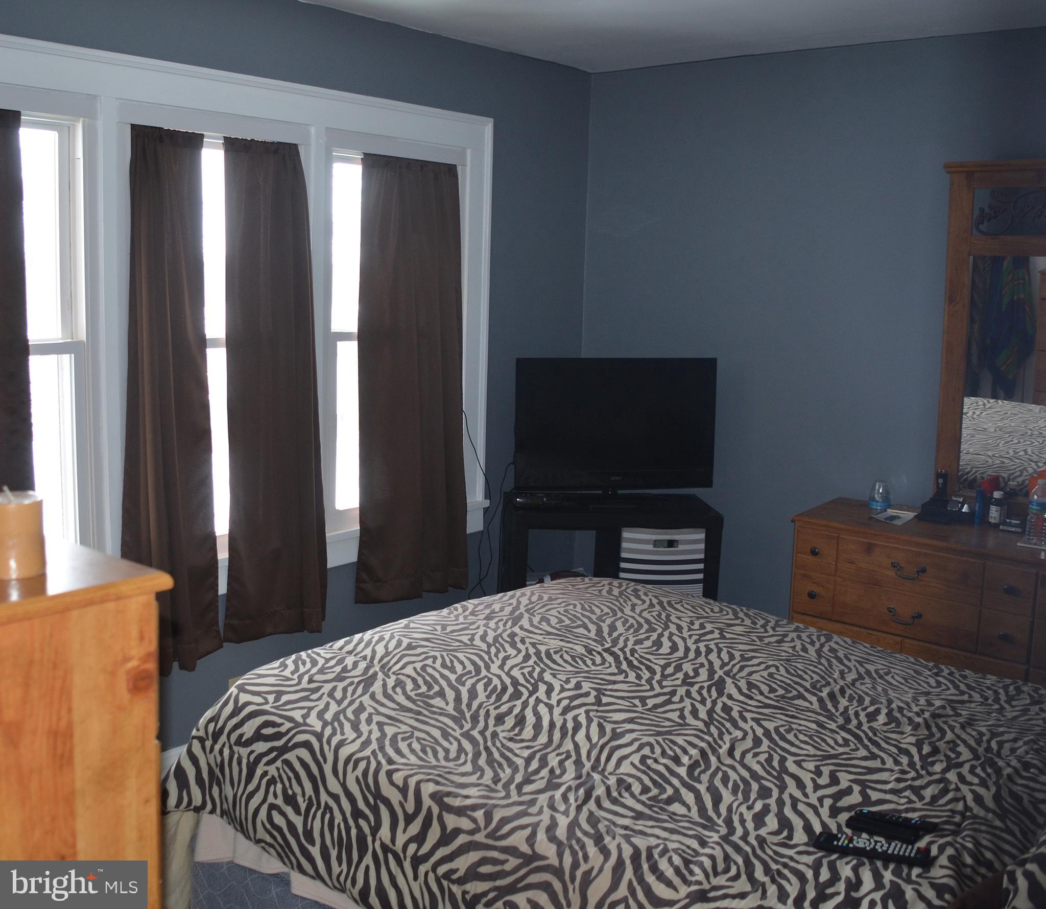 140 Case Avenue Sharon, PA 16146 - Photo 15 of 23 a bedroom with a bed and a flat screen tv