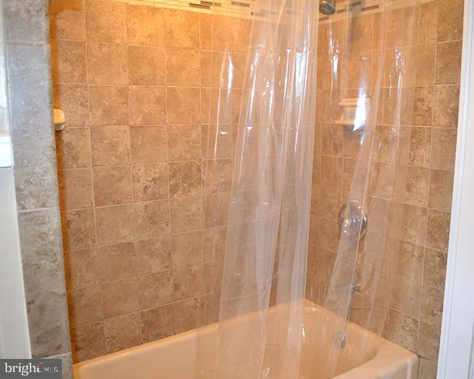 140 Case Avenue Sharon, PA 16146 - Photo 18 of 23 a bathroom with a shower curtain and a bath tub