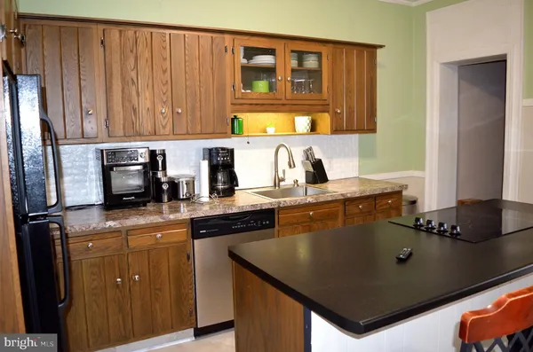 a kitchen with granite countertop a sink cabinets and window