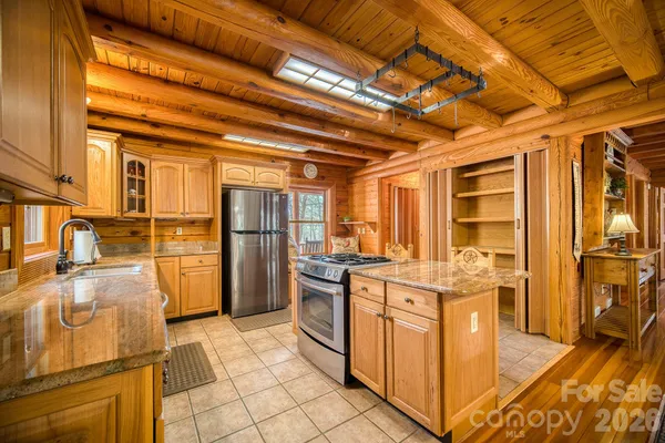 a kitchen with stainless steel appliances granite countertop a stove and a refrigerator
