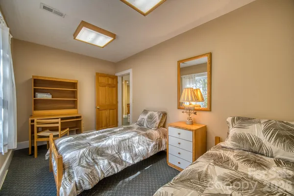 a bedroom with a bed and a dresser