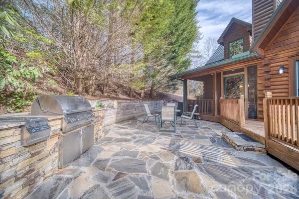 a view of a patio with table and chairs and wooden floor