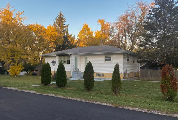 a front view of house with a garden and patio