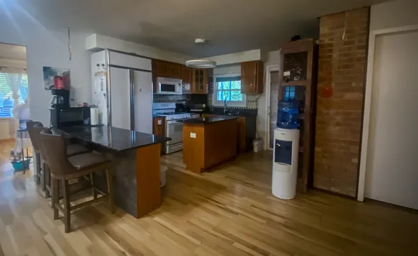 a kitchen with stainless steel appliances a refrigerator and a stove top oven