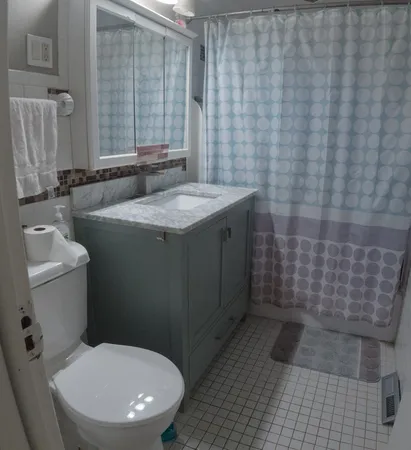 a bathroom with a toilet and a shower