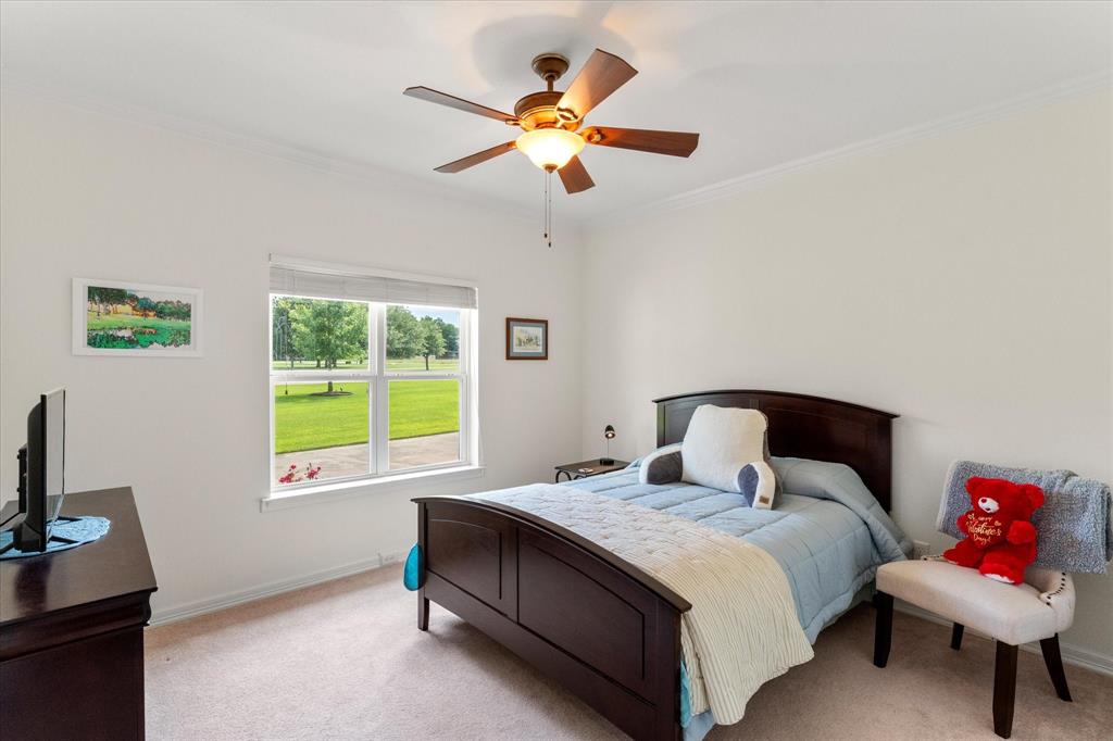 345 Rains County Road 3390 Emory, TX 75440 - Photo 30 of 39 a bedroom with a bed and a chandelier