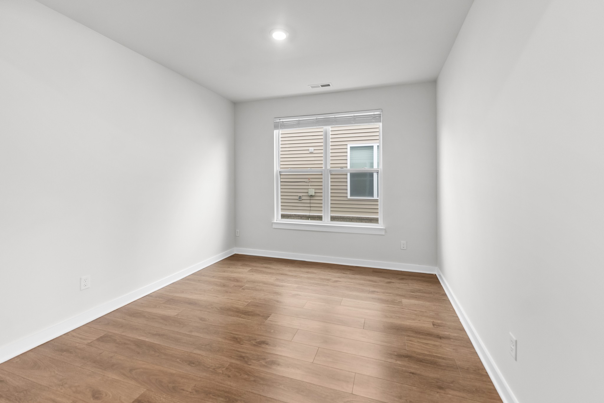 1255 Inverness Pass Lebanon, TN 37087 - Photo 18 of 40 an empty room with wooden floor and windows