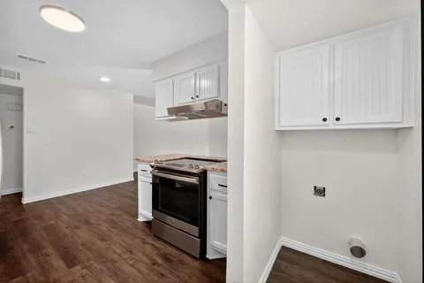 a view of a kitchen with electric appliances
