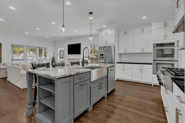 a kitchen with granite countertop a sink appliances and cabinets