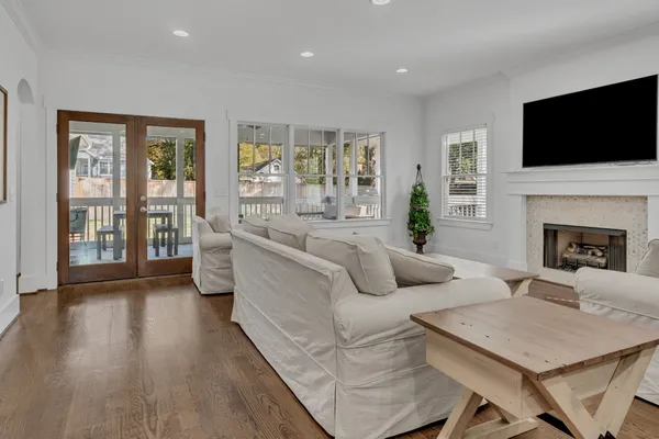 a living room with fireplace furniture and a flat screen tv