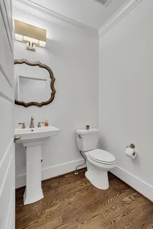 a bathroom with a sink toilet and mirror