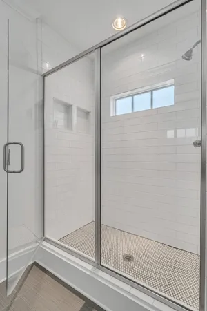 a bathroom with a glass shower door