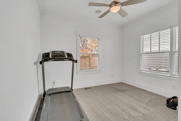 a room with gym equipment and windows